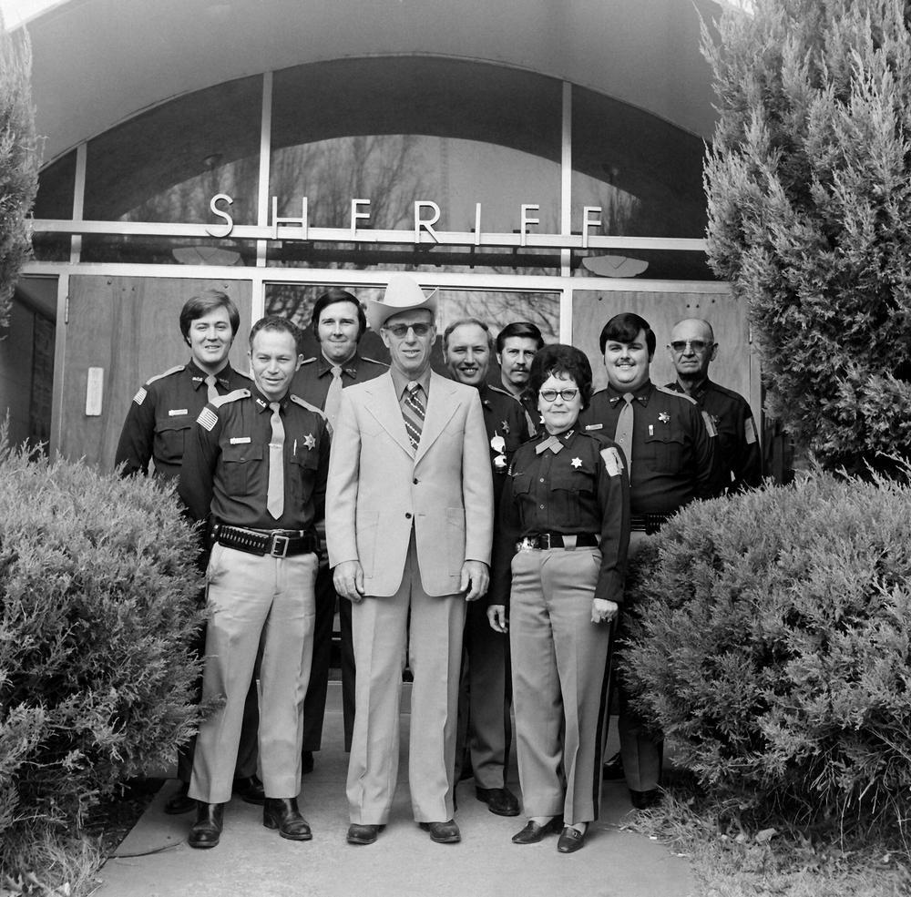 Sheriff's office staff in front of office front door